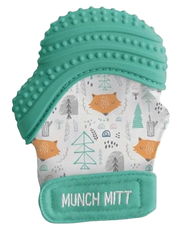 Teal silicone teething mitt with forest pattern on a white background