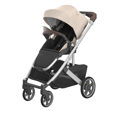 Stroller with beige canopy and black seat on a white background
