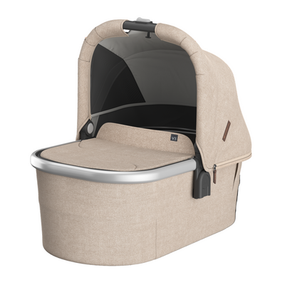 UPPAbaby Bassinet V3 in oat melange color with sunshade, mesh panels, and a breathable mattress designed for infant sleep safety.