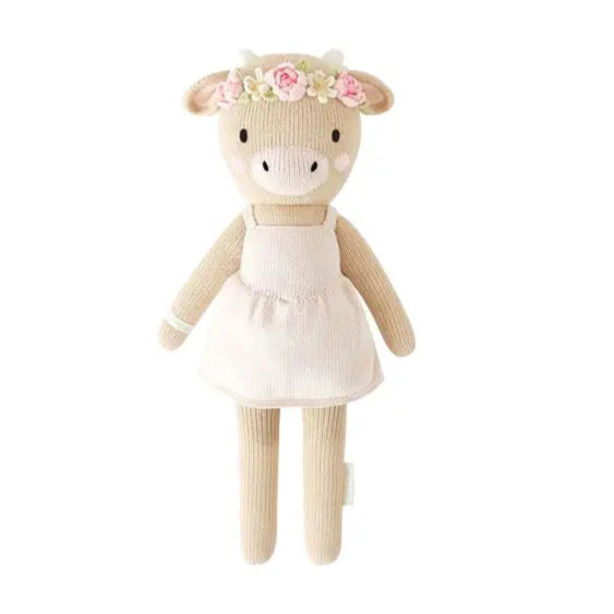 Stuffed animal toy with a white dress and floral headband on a white background