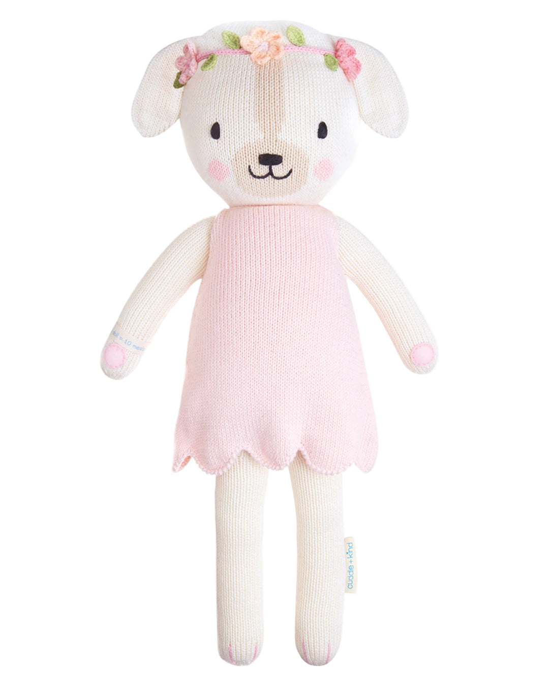 Plush toy dog in a pink dress with a white background