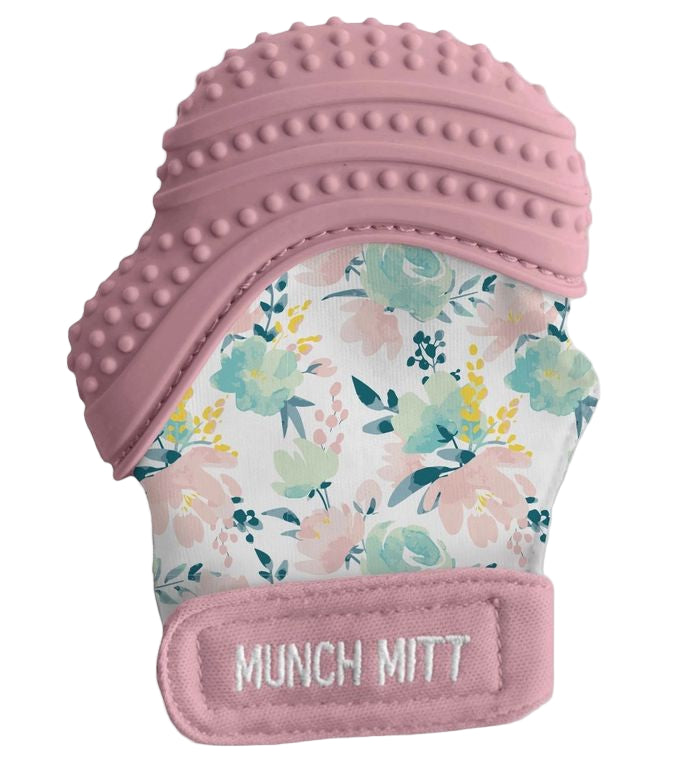 Floral-patterned teething mitt with pink textured top on a white background