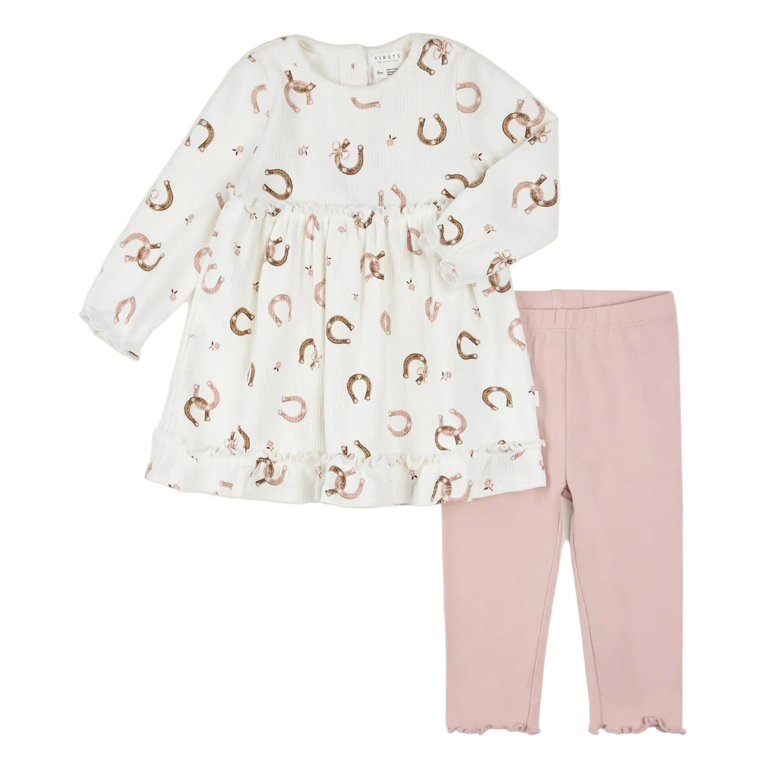 A toddler girl's two-piece clothing set featuring a long-sleeve white dress with a metallic rose gold horseshoe pattern, paired with matching dusty pink leggings, laid flat on a white background.