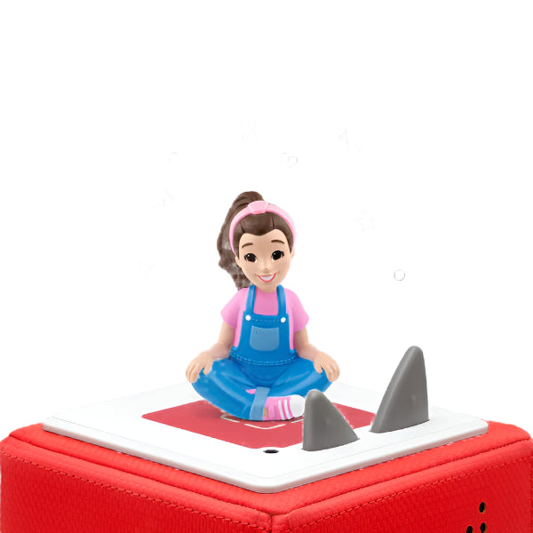 Toy figure of a girl in blue overalls sitting on a red and white block with shark fins.